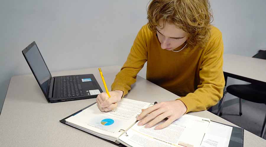 Kid doing virtual class homework at Options Charter Schools