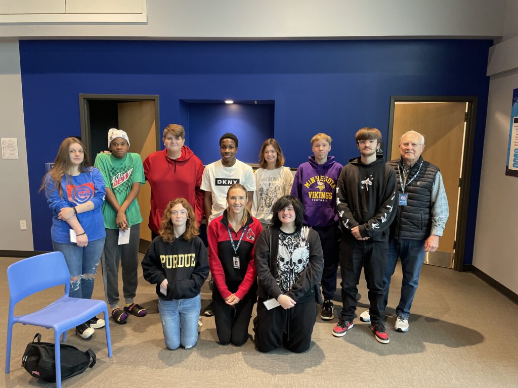 Options Schools student pose for a photo in two lines. A group is standing and a group is kneeling