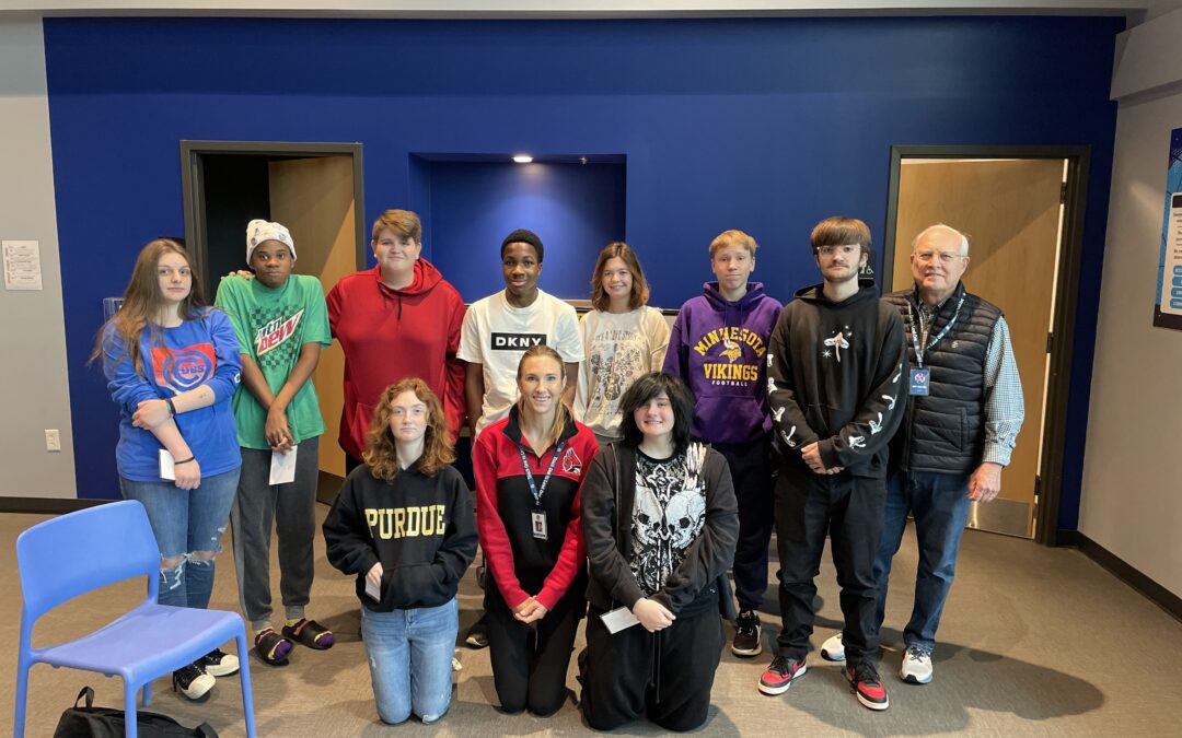 Options Schools student pose for a photo in two lines. A group is standing and a group is kneeling